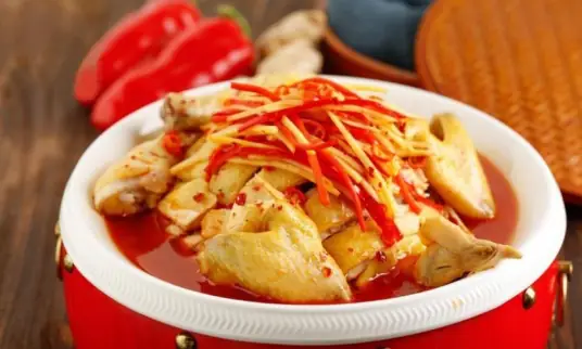 东安鸡菜呈红黄两色，鸡肉肥嫩多汁，味道酸辣鲜香